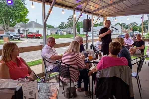 priest talking to people during event in maryville il