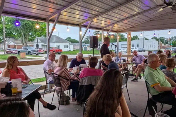 priest talking to people during event in maryville il